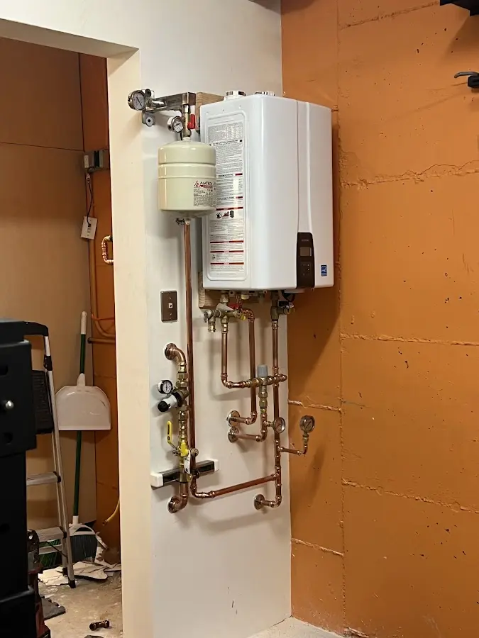 Plumbing technician inspecting water heater connections in Monrovia